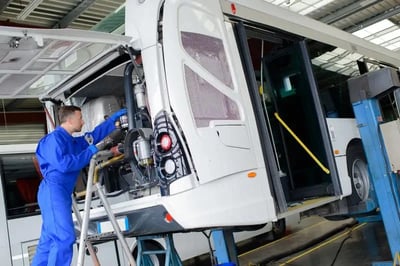 Mechanic Working On Bus  equipped with Coencorp's automatic vehicle data unit with no recurring fees