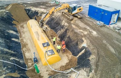 Underground fuel Tank Being Installed bny a crane and construction crew