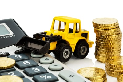 toy loader next to calculator and piles of coins coencorp automated fueling smart investment