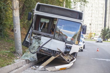 Damaged transit city bus from an accident caused by poor brake maintenance.