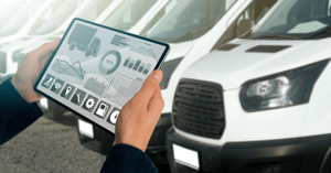 fleet manager holding a tablet with Fleet-management software to help manage his fleet of service vehicles.