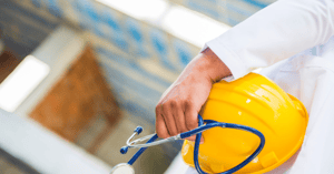 man holding yellow hard hat and stethoscope signifying fleet-management-health-and-safety