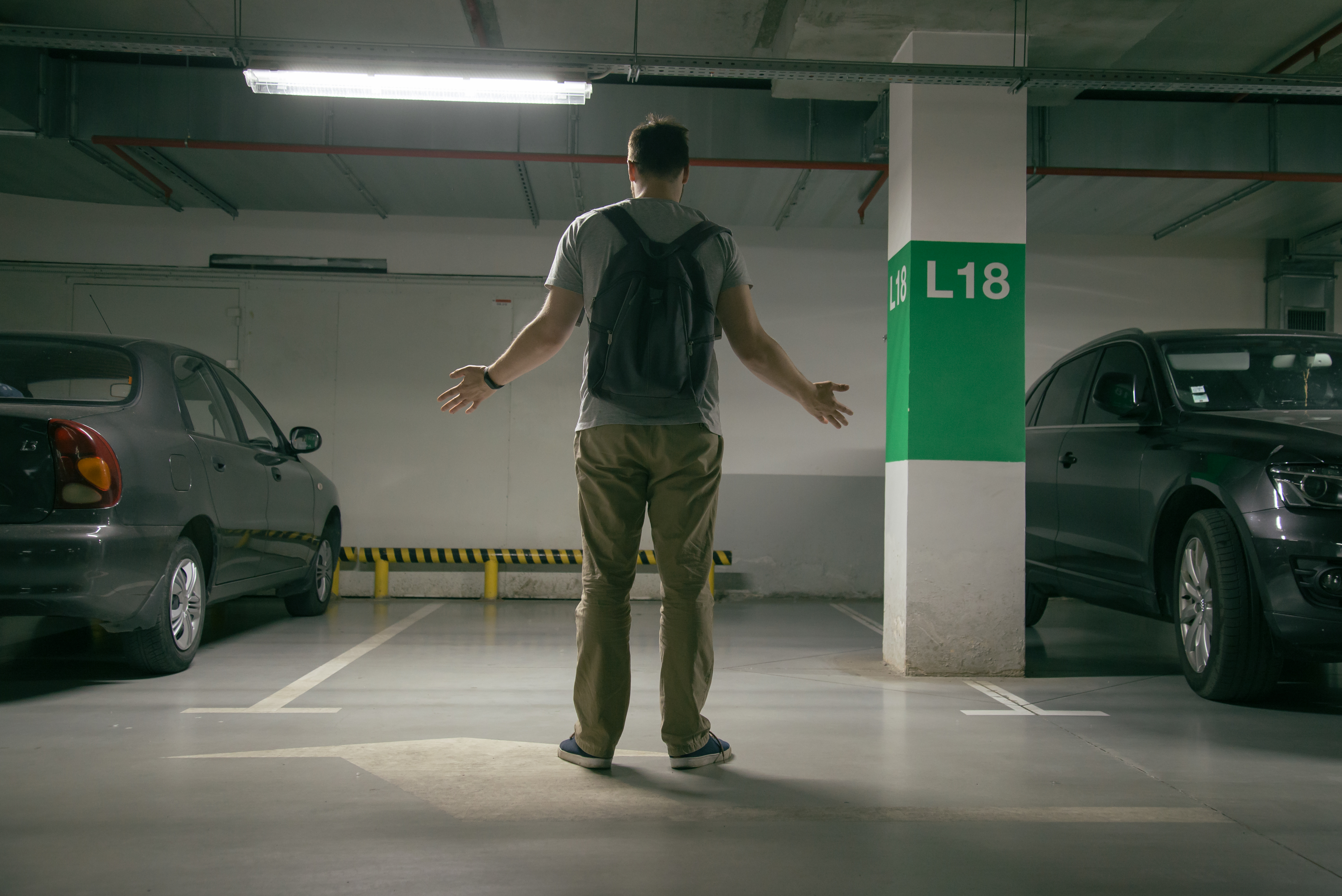 Fleet car owner standing in front of an empty parking space.
